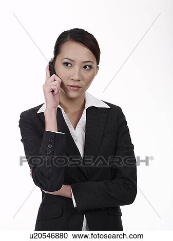 Stock Image - Businesswoman using mobile phone. Fotosearch