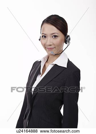 Stock Photo - Woman wearing headset, portrait, close-up. Fotosearch