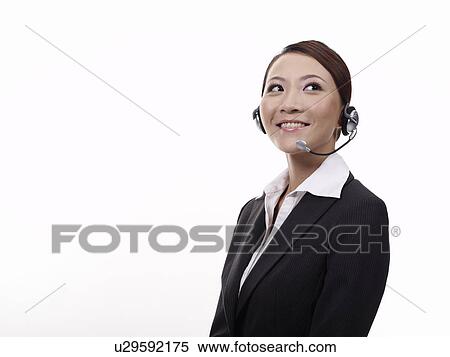 Stock Photography - Woman wearing headset, portrait, close-up. Fotosearch