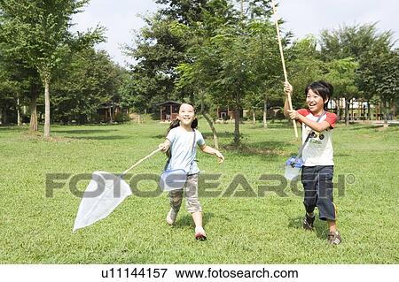 Boy and girl running with butterfly net View Large Photo Image Stock Photo - Boy and girl running with butterfly net. Fotosearch