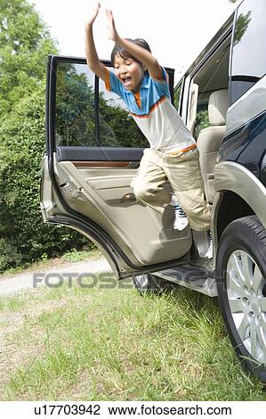 Boy jumping out of car View Large Photo Image Stock Image - Boy jumping out of car. Fotosearch
