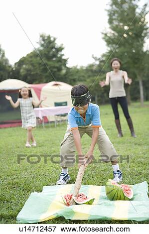 Boy Splitting Watermelon with Blindfold View Large Photo Image Stock Photo - Boy Splitting Watermelon with Blindfold. Fotosearch