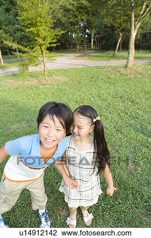 Stock Image - Brother and Sister on Field. Fotosearch