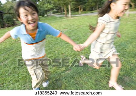 Stock Photo - Brother and Sister Running in Field. Fotosearch