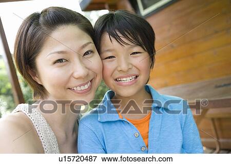 Stock Photo - Close up of mother and son, looking at camera. Fotosearch