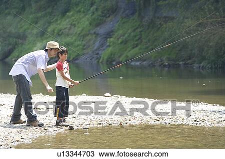 Stock Image - Father and Son Fishing by Stream. Fotosearch