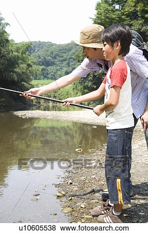 Stock Photo - Father and son fishing by stream. Fotosearch