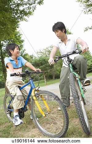 Father and Son Riding Bicycles View Large Photo Image Picture - Father and Son Riding Bicycles. Fotosearch