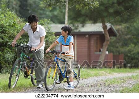 Picture - Father and son riding bicycles. Fotosearch