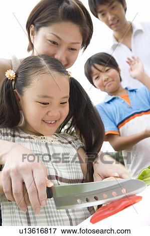 Stock Photo - Mother and Daughter Cooking Together. Fotosearch