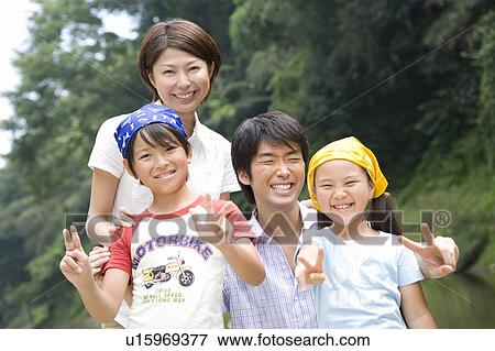 Stock Photo - Portrait of family, smiling, looking at camera. Fotosearch
