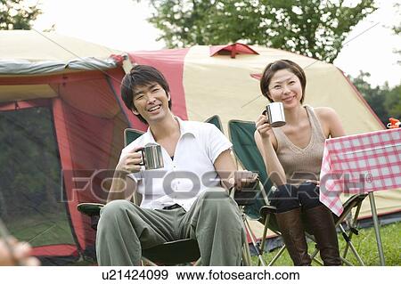 Stock Photo - Young Couple Drinking Coffee and Relaxing. Fotosearch