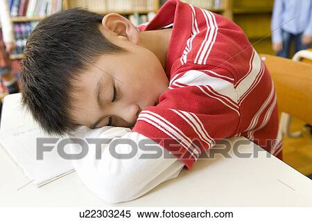 Stock Photography - A Boy Sleeping In The Library. Fotosearch
