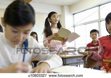 Stock Photo - Elementary Girl Reading Aloud in Class. Fotosearch