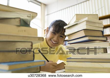 Elementary Girl Studying In The Library View Large Photo Image Stock Photo - Elementary Girl Studying In The Library. Fotosearch