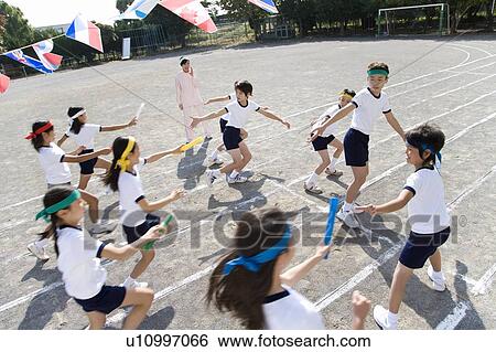 Elementary Students Handing Batons View Large Photo Image Stock Photograph - Elementary Students Handing Batons. Fotosearch