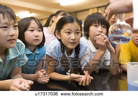 Stock Photograph - Elementary Students Watching Experiment. Fotosearch