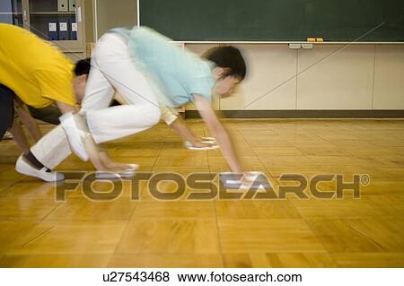 Japanese Boys Cleaning up the floor of Classroom View Large Photo Image Stock Photo - Japanese Boys Cleaning up the floor of Classroom. Fotosearch