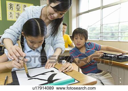 Stock Photo - Japanese Girl Learning Calligraphy. Fotosearch