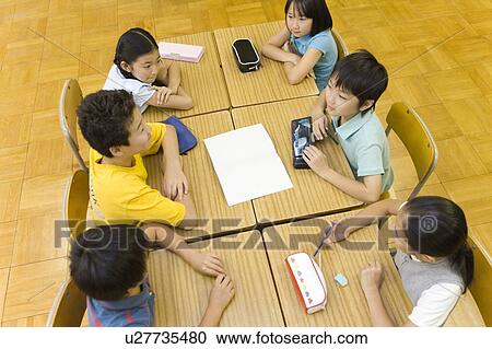 Stock Image - Japanese Students Discussing In The Classroom. Fotosearch
