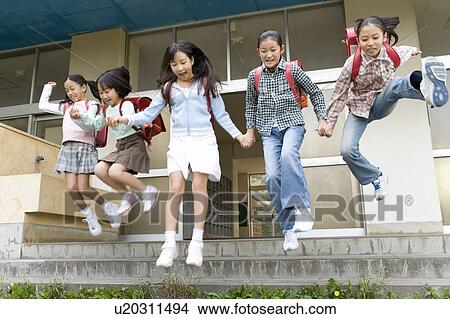 Picture - Japanese Students Jumping Over Steps. Fotosearch