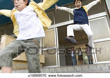 Stock Image - Japanese Students Jumping Over Steps. Fotosearch