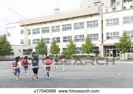 Stock Photo - Japanese Students Running At Schoolyard. Fotosearch