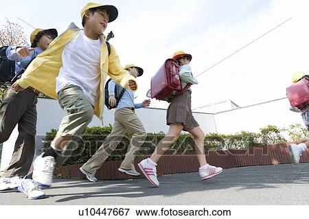 Stock Photo - Japanese Students Running On The Street. Fotosearch