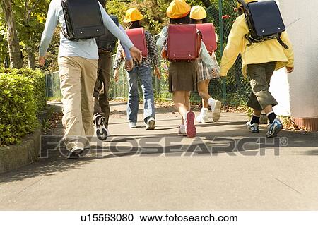 Stock Image - Japanese Students Walking On The Street. Fotosearch
