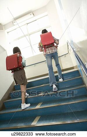 Stock Image - Japanese Students Walking Up Stairs. Fotosearch