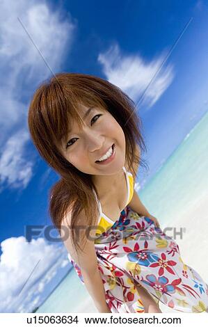 Picture - Portrait of a young woman on beach, smiling, Saipan, USA . Fotosearch