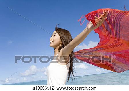 Woman holding fabric behind back on beach, smiling and closing eyes, Saipan, USA View Large Photo Image Stock Image - Woman holding fabric behind back on beach, smiling and closing eyes, Saipan, USA . Fotosearch