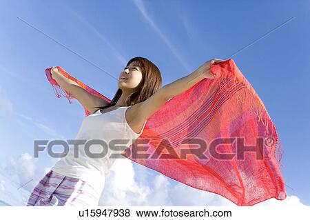Woman holding fabric behind back on beach, smiling, Saipan, USA View Large Photo Image Stock Photo - Woman holding fabric behind back on beach, smiling, Saipan, USA . Fotosearch