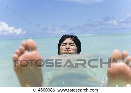 Young man in the sea, closing eyes, differential focus, Saipan, USA View Large Photo Image Stock Photography - Young man in the sea, closing eyes, differential focus, Saipan, USA . Fotosearch