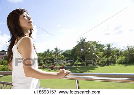 Stock Photo - Young woman looking at the view, Saipan. Fotosearch