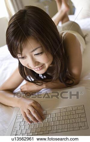 Young woman using a laptop, Saipan, Focus on Foreground View Large Photo Image Stock Image - Young woman using a laptop, Saipan, Focus on Foreground. Fotosearch