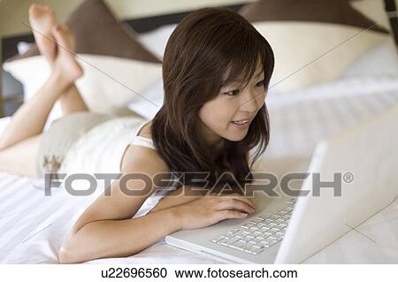 Young woman using a laptop, Saipan, Focus on Foreground View Large Photo Image Stock Image - Young woman using a laptop, Saipan, Focus on Foreground. Fotosearch