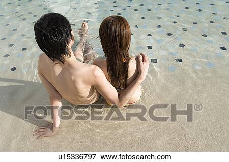 Couple in a swimming pool, Saipan, Rear View View Large Photo Image Stock Photo - Couple in a swimming pool, Saipan, Rear View. Fotosearch