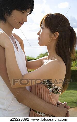 Stock Image - Young couple embracing, Saipan, USA . Fotosearch