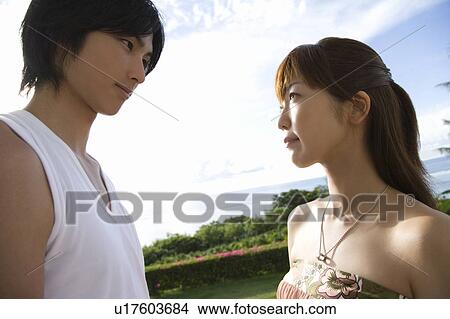 Picture - Young couple looking at each other, Saipan, USA . Fotosearch