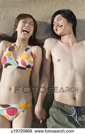 Young couple lying in swimming pool, Saipan View Large Photo Image Stock Photo - Young couple lying in swimming pool, Saipan. Fotosearch