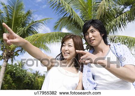 Stock Image - Young couple Pointing, Saipan. Fotosearch