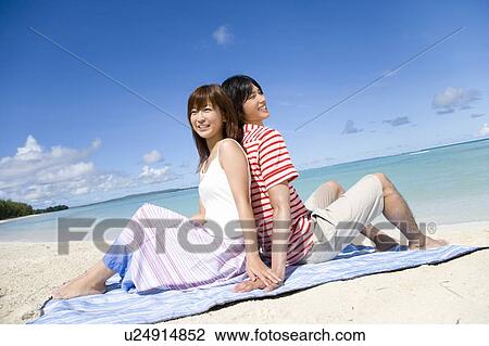 Young couple sitting on beach, back to back, Saipan, USA View Large Photo Image Stock Image - Young couple sitting on beach, back to back, Saipan, USA . Fotosearch