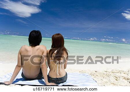 Young couple sitting on beach, Saipan, USA View Large Photo Image Stock Image - Young couple sitting on beach, Saipan, USA . Fotosearch