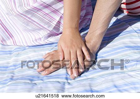 Young woman putting hand on man's hand, Saipan, USA View Large Photo Image Stock Photo - Young woman putting hand on man's hand, Saipan, USA . Fotosearch