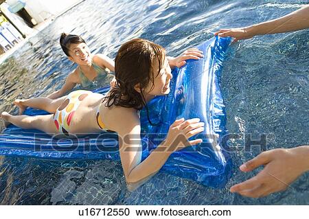 Friends playing in a swimming pool, Saipan View Large Photo Image Stock Image - Friends playing in a swimming pool, Saipan. Fotosearch