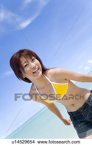 Portrait of a young woman on beach, smiling, Saipan, USA View Large Photo Image Picture - Portrait of a young woman on beach, smiling, Saipan, USA . Fotosearch