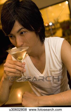 Young man drinking a cocktail, Saipan View Large Photo Image Stock Photo - Young man drinking a cocktail, Saipan. Fotosearch