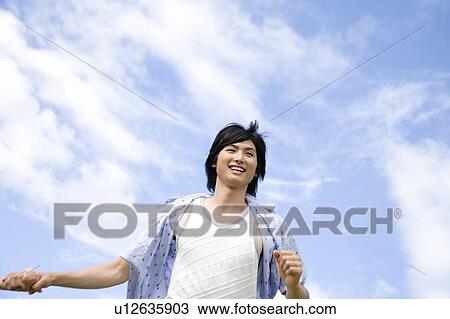 Stock Image - Young man running, Saipan. Fotosearch