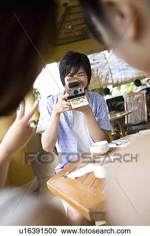 Young man taking photo of women, Saipan View Large Photo Image Stock Image - Young man taking photo of women, Saipan. Fotosearch